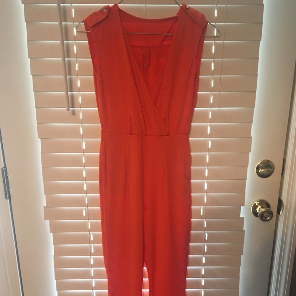 Small orange jumpsuit with deep v neckline